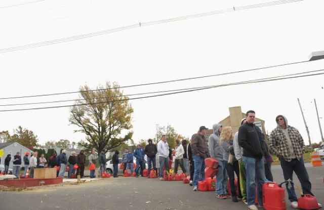 People line up to fill gas canisters at a Shell gas station on November 2, 2012 in Matawan, New Jersey
